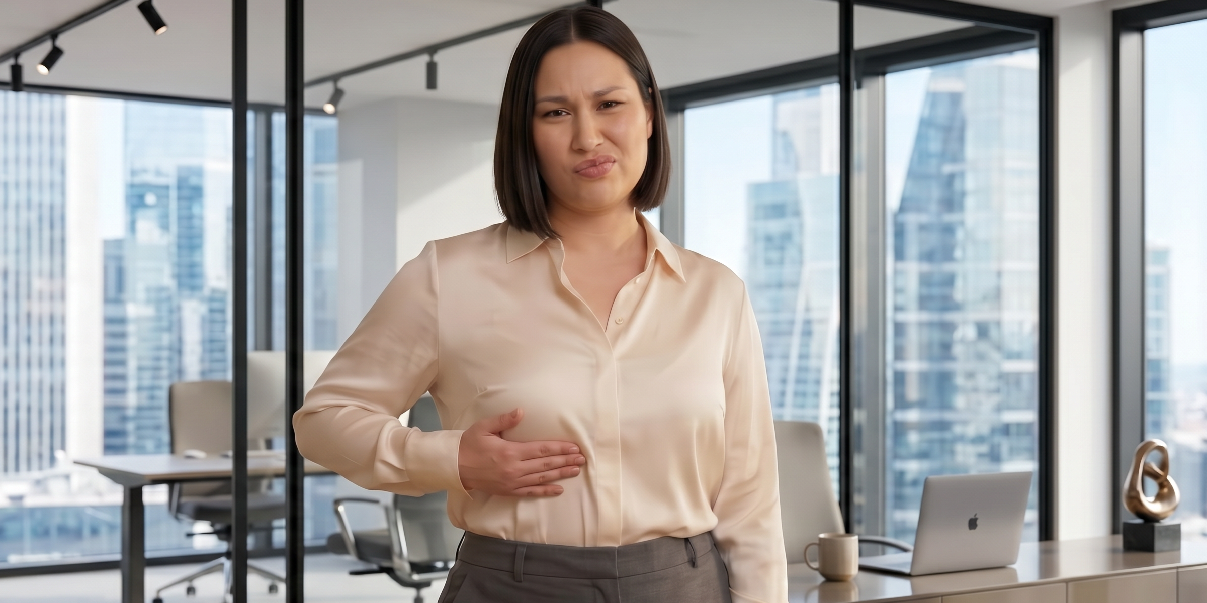 Woman in business attire reacting to underwire discomfort